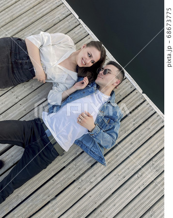Young couple relaxing on pier in summer 68673775