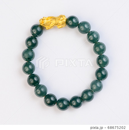 Green jade bracelet on white background 68675202
