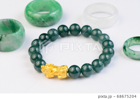 Green bracelet jade with jadeite ring on background 68675204