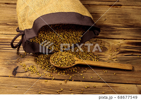 Fenugreek seeds on wooden table Fenugreek seeds on wooden table 68677549