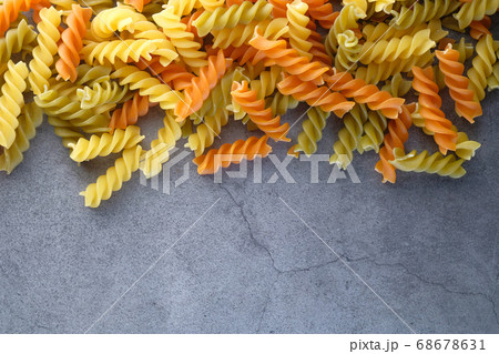 Variety of types and shapes of dry Italian pasta on black background Variety of types and shapes of dry Italian pasta on black background 68678631