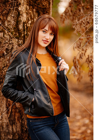 beautiful woman near tree in autumn Park. 68679777