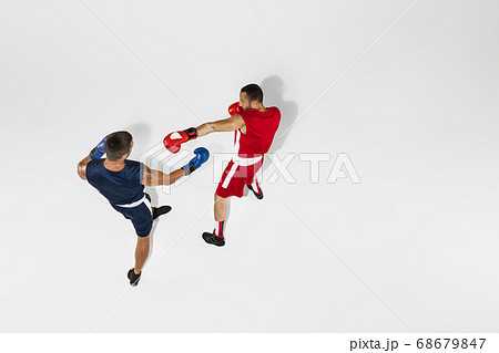 Two professional boxers boxing isolated on white studio background, action, top view Two professional boxers boxing isolated on white studio background, action, top view 68679847