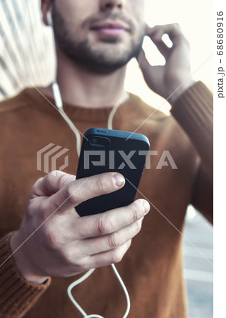 Portrait of smiling man with headphones and 68680916
