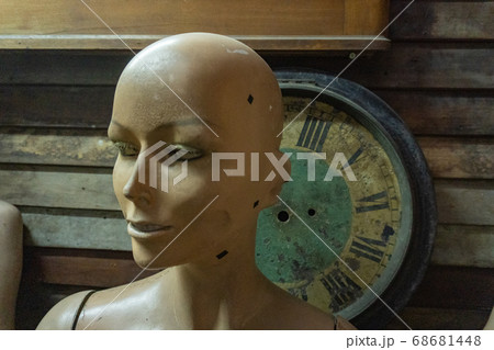 Creepy woman's head dummy and a clock in the background Creepy woman's head dummy and a clock in the background 68681448