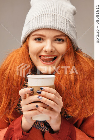 Woman holding hot coffee on winter day 68681611