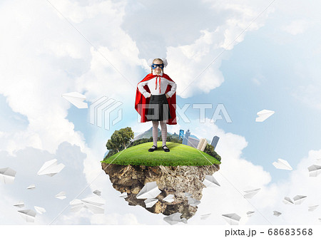 Girl power concept with cute kid guardian against cityscape background Girl power concept with cute kid guardian against cityscape background 68683568