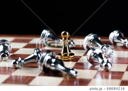 Gold pawn chess defeats silver figures on board. 68684216