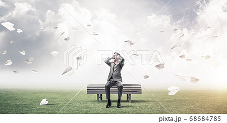 Young man in suit in park dont want to hear anything 68684785