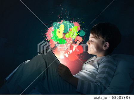 Boy with tablet in his bed Boy with tablet in his bed 68685303