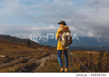 young man in fashion clothes walking on a cloudy day 68686566
