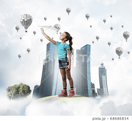 Concept of careless happy childhood with girl dreaming about future 68686834