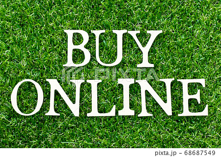 Wood alphabet letter in word buy online on green grass background Wood alphabet letter in word buy online on green grass background 68687549