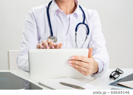 Close up female doctor hands using tablet computer Close up female doctor hands using tablet computer 68689146