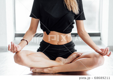 close up cropped photo. young female sitting in the lotus posture 68689211