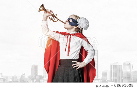 Girl power concept with cute kid guardian against cityscape background Girl power concept with cute kid guardian against cityscape background 68691009