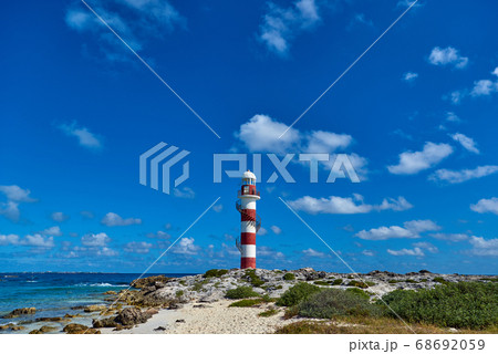 Lighthouse on a rocky shore in Cancun. Clear sky Lighthouse on a rocky shore in Cancun. Clear sky 68692059
