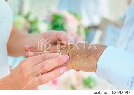 Hands of the newlyweds at the wedding ceremony of 68692093