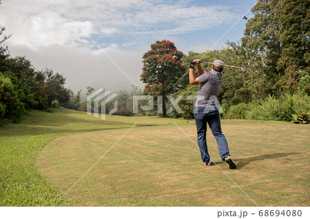 A person playing golf. A person playing golf. 68694080
