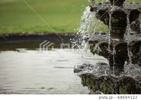 A waterfall coming out of the water 68694122
