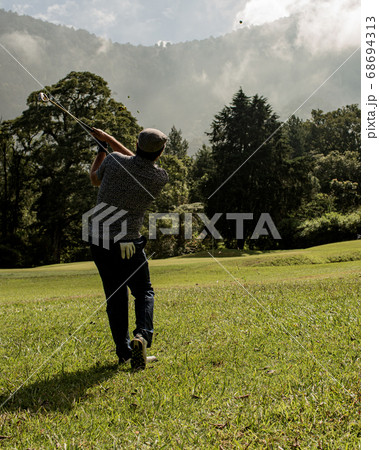 A person standing on top of a grass covered field 68694313