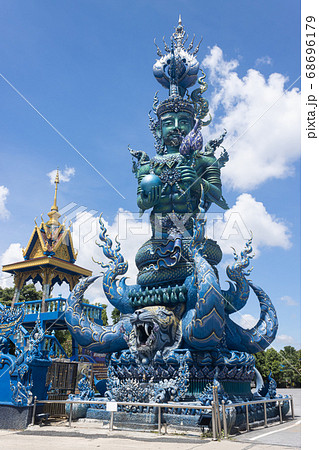 Green God Statue Hold Lotus and Ball on Blue Sky Background 68696179