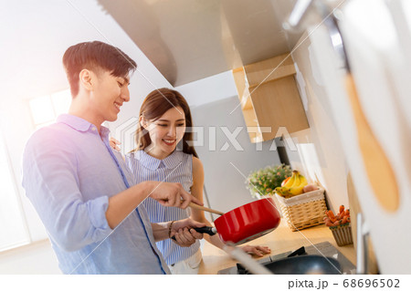 asian couple cook happily 68696502
