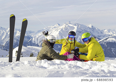 Three happy friends snowboarders and skier are 68698593
