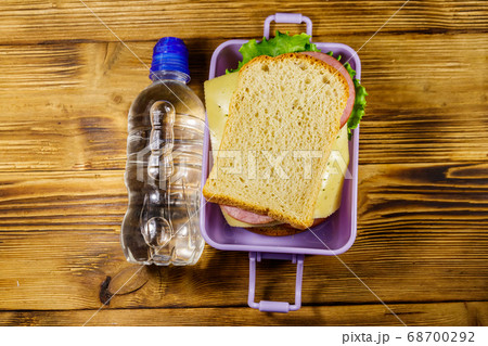 Lunch box with sandwiches and bottle of water  68700292
