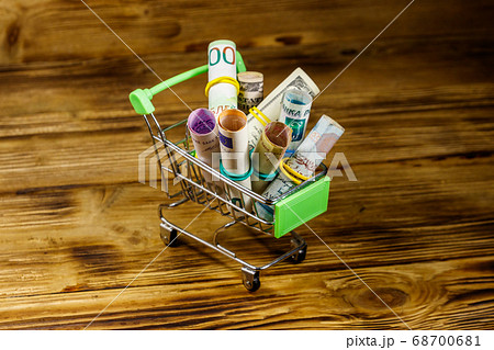 Shopping cart with money from different countries Shopping cart with money from different countries 68700681