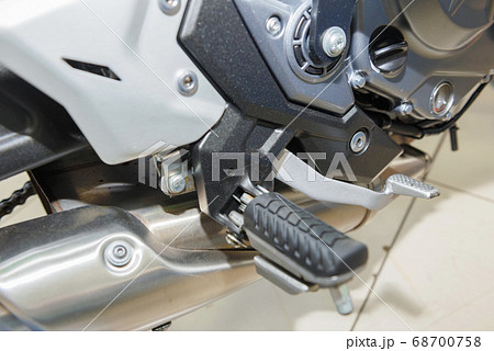 The master performs maintenance on the motorcycle. 68700758