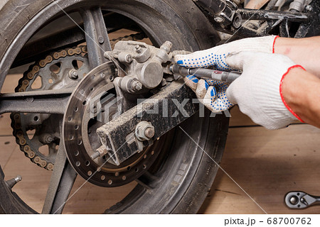 The process of replacing brake pads on a The process of replacing brake pads on a 68700762