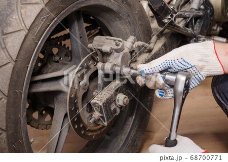 The process of replacing brake pads on a The process of replacing brake pads on a 68700771