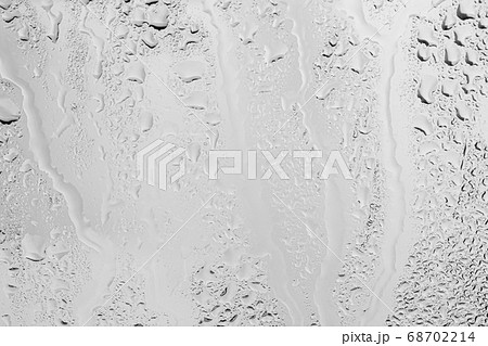 Rain drops on window glasses surface with gray sky background . Natural backdrop of raindrops. Overlay for design. The concept of bad rainy weather. 68702214