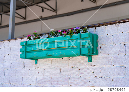 wooden planters for flowers on wall of house.  68708445