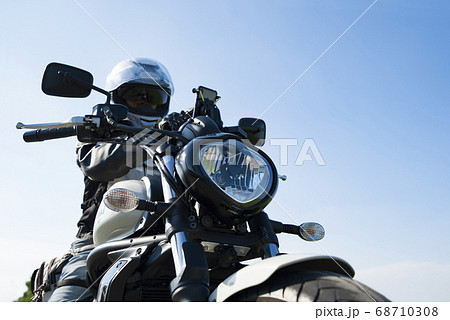 バイクライフ スマホを操作する中年ライダーとミドルクルーザー 千葉県の写真素材