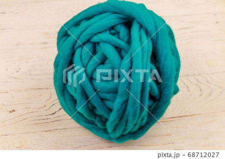 Merino wool yarn ball on white wooden background 68712027