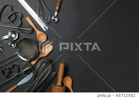 Kitchen utensils for pastries on black table and 68712082