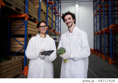 Two pleased warehouse employees smiling at the camera 68717426