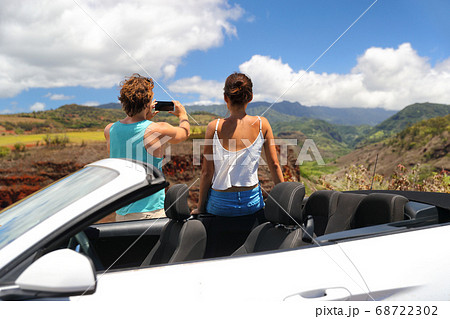 Road trip car people taking picture of landscape 68722302