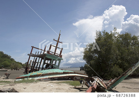 An old ruined sailboat abandoned in the beach An old ruined sailboat abandoned in the beach 68726388
