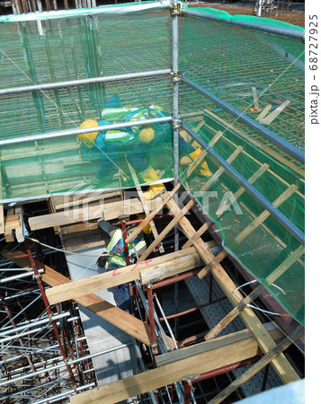 KUALA LUMPUR, MALAYSIA -MARCH 05, 2020: Construction workers installing & fabricating timber formwork at the construction site. The formworks made from timber and plywood.  68727925