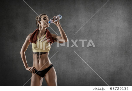 young fitness woman with bottle water in gym 68729152
