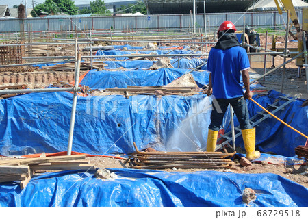 JOHOR, MALAYSIA -MARCH 29, 2016: Construction workers spraying the anti termite chemical treatment to the soil at the construction site.  68729518