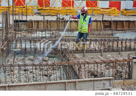 JOHOR, MALAYSIA -MARCH 29, 2016: Construction workers spraying the anti termite chemical treatment to the soil at the construction site.  68729531