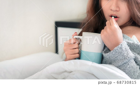 Sick asian woman have hight fever flu and take 68730815