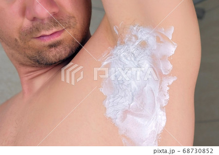 Depilation cream on armpit of young man, closeup view. 68730852