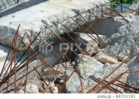 MALACCA, MALAYSIA -JUNE 14, 2016: The ruins of concrete walls and exposed steel reinforcements inside. MALACCA, MALAYSIA -JUNE 14, 2016: The ruins of concrete walls and exposed steel reinforcements inside. 68731165