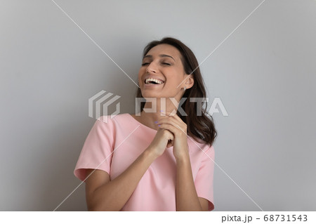 Happy young ethnic woman laugh at funny joke Happy young ethnic woman laugh at funny joke 68731543