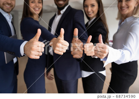 Smiling diverse teammates recommend goods or service of their company Smiling diverse teammates recommend goods or service of their company 68734590